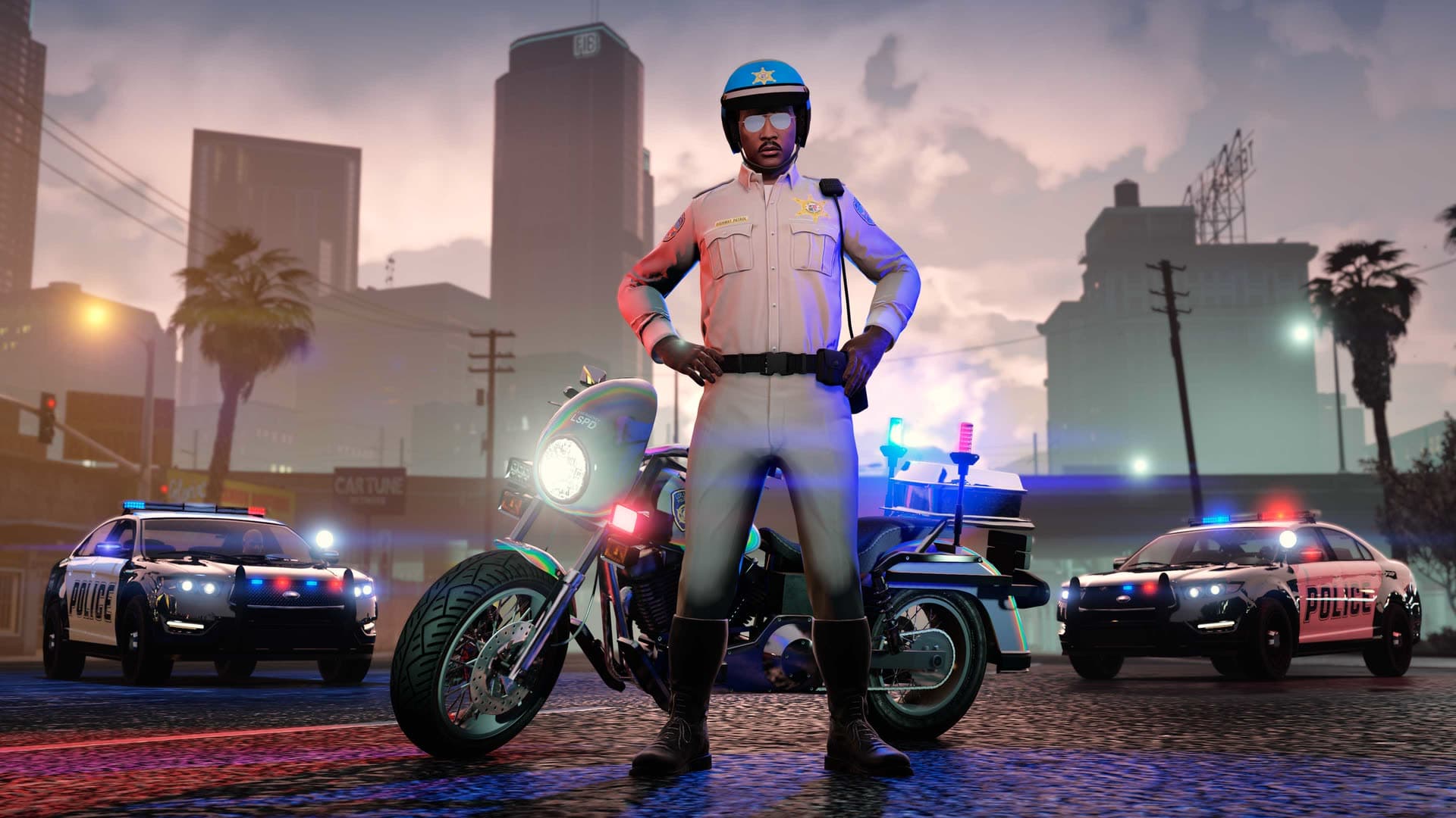 A police officer beside patrol cars